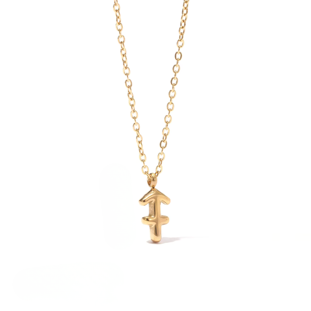 All 12 zodiac symbol bubble necklaces in 18K gold PVD displayed on a stone surface. Bold, chunky glyph pendants on delicate cable chains — waterproof and tarnish-free.