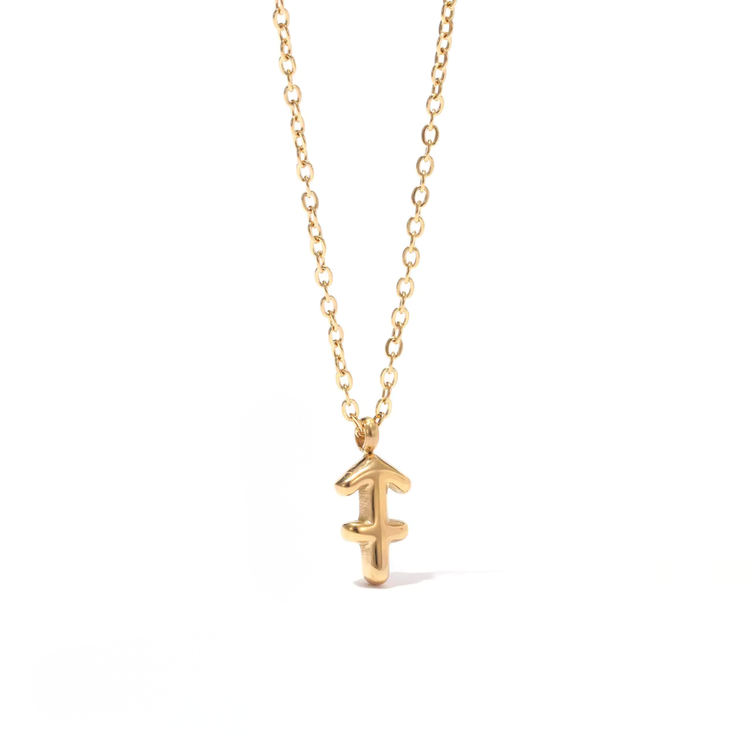 All 12 zodiac symbol bubble necklaces in 18K gold PVD displayed on a stone surface. Bold, chunky glyph pendants on delicate cable chains — waterproof and tarnish-free.