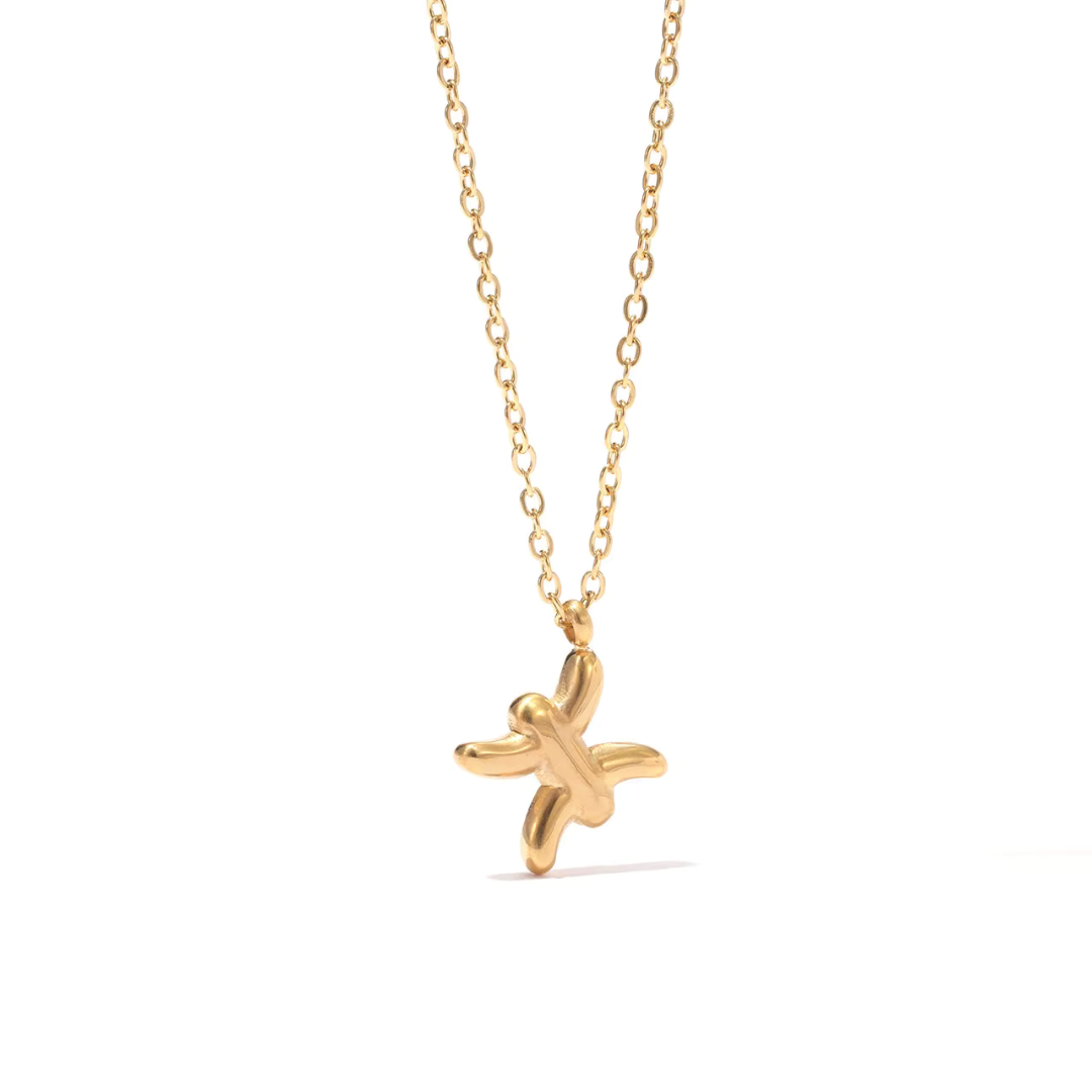 All 12 zodiac symbol bubble necklaces in 18K gold PVD displayed on a stone surface. Bold, chunky glyph pendants on delicate cable chains — waterproof and tarnish-free.
