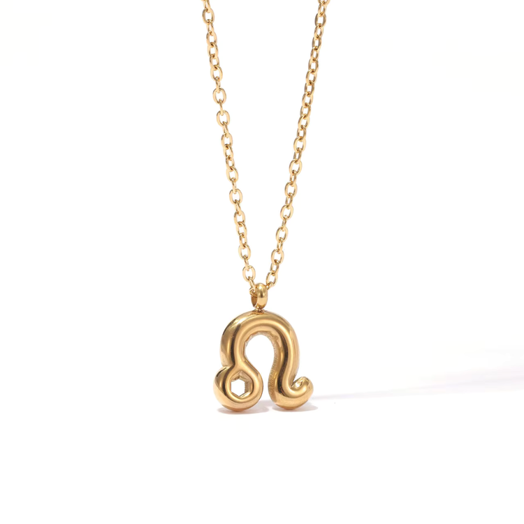 All 12 zodiac symbol bubble necklaces in 18K gold PVD displayed on a stone surface. Bold, chunky glyph pendants on delicate cable chains — waterproof and tarnish-free.